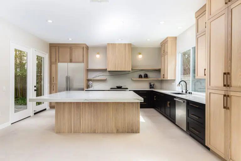 Custom kitchen remodel with big island. Kitchen design is black and white oak cabinets