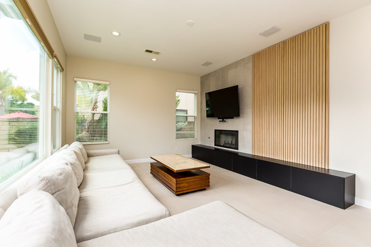 Linear fireplace with floor to ceiling tile and vertical white oak slat panel Carmel Valley 92130