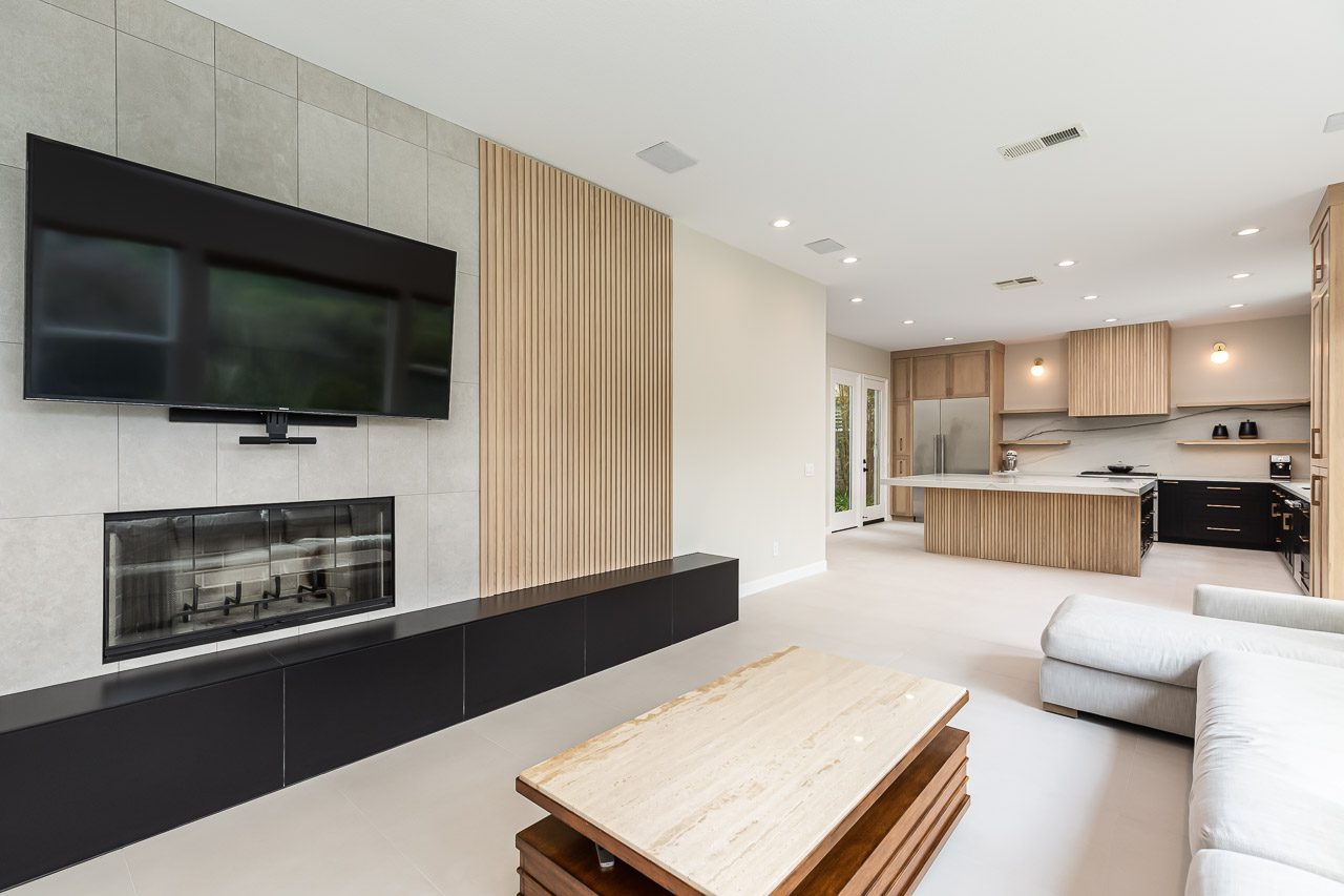 Modern living room remodel with white oak fluted fireplace in San Diego Carmel Valley