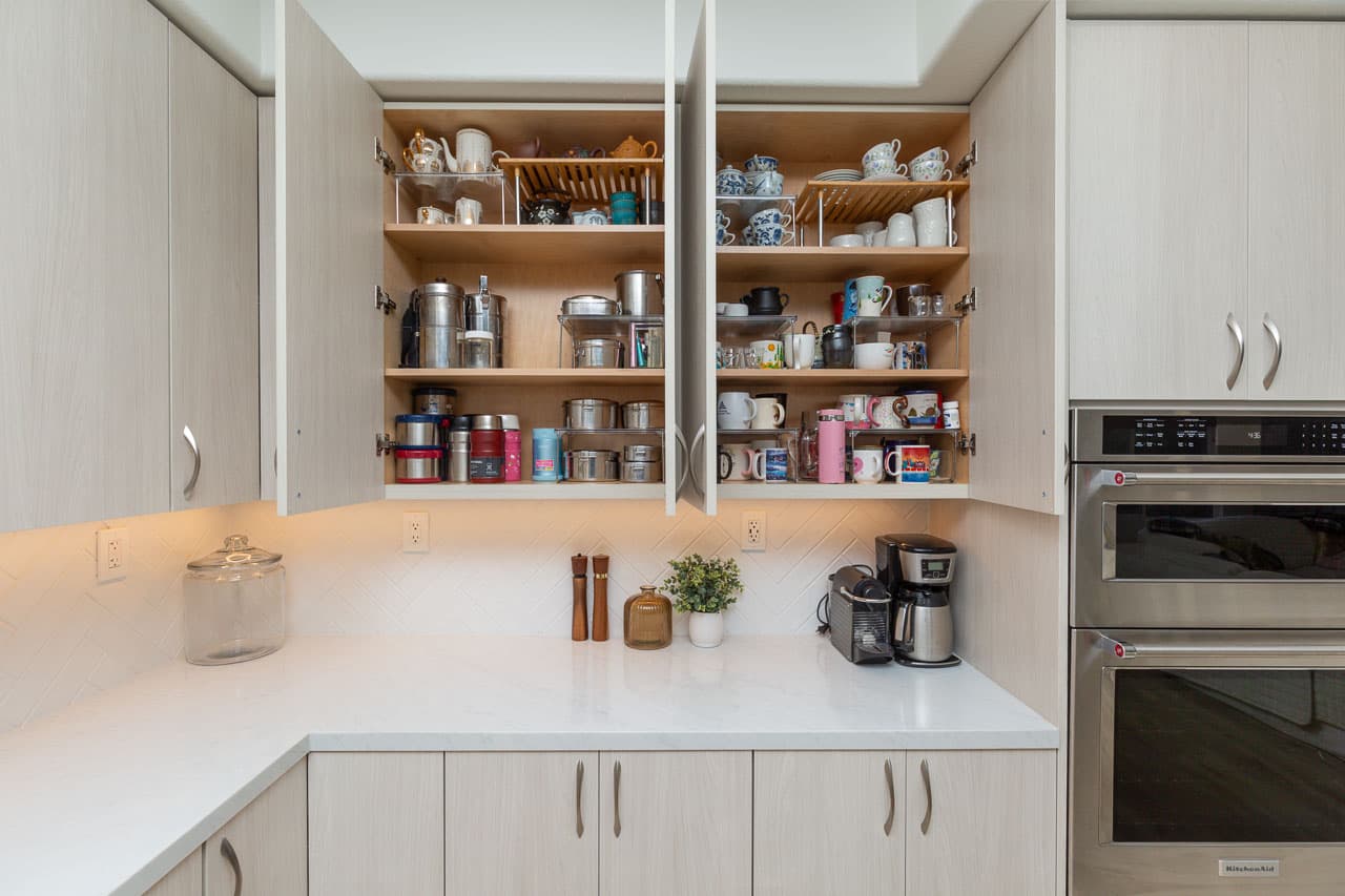 Kitchen cabinets open showing organized storage Carlsbad remodel