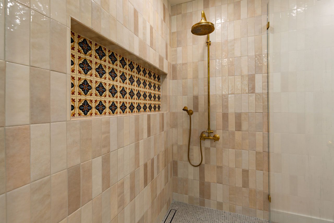 Large-format porcelain tile bathroom remodel San Diego — floor-to-ceiling marble-look tile, minimal grout lines, fluted accent wall
