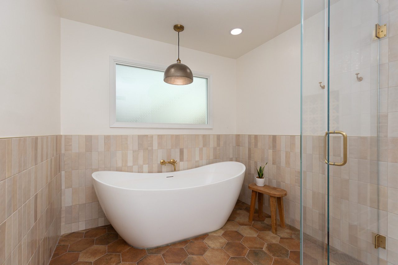 Freestanding soaking tub with brass wall filler and pendant light, master bath remodel Mission Hills San Diego 92103