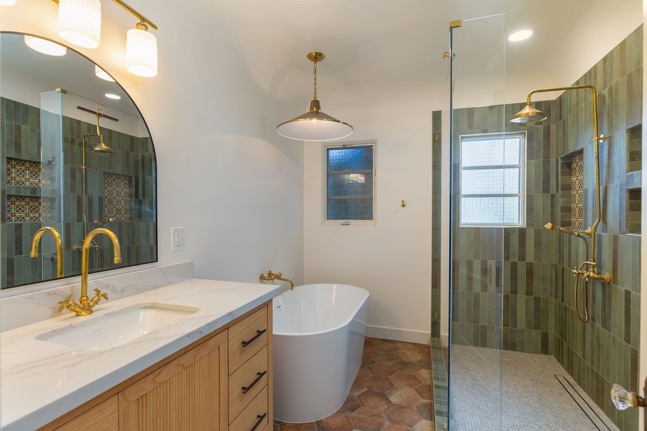 Spanish Revival bathroom remodel Mission Hills San Diego 92103 — well-resolved layout with freestanding tub, white oak fluted vanity, walk-in shower with Talavera niche accents