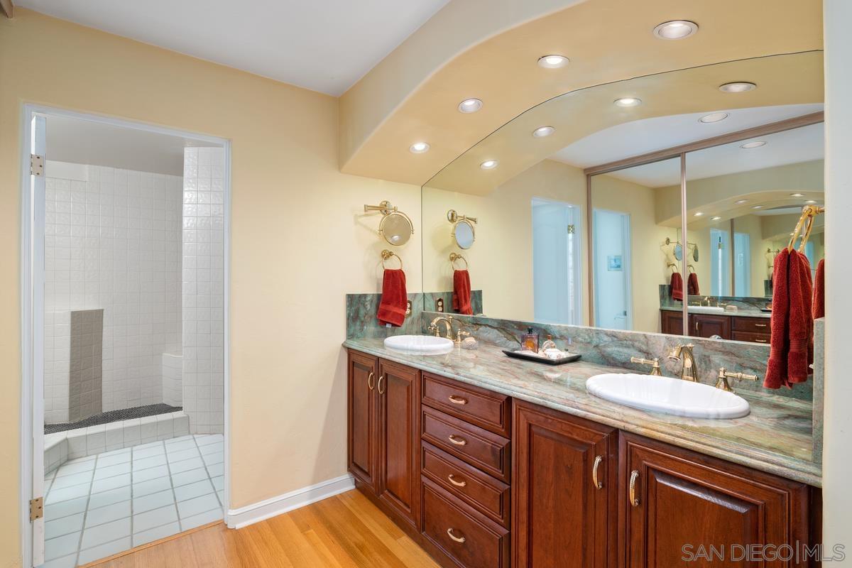 Master bathroom before remodel with cherry cabinets and marble vanity top
