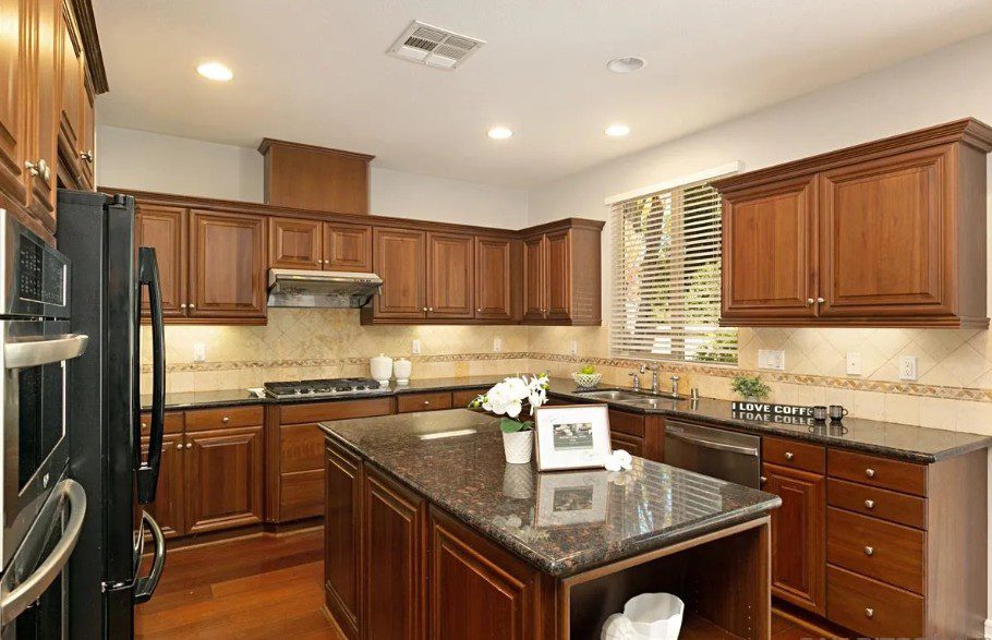 Before: dark oak kitchen with granite counters, Black Colt Lane Carmel Valley