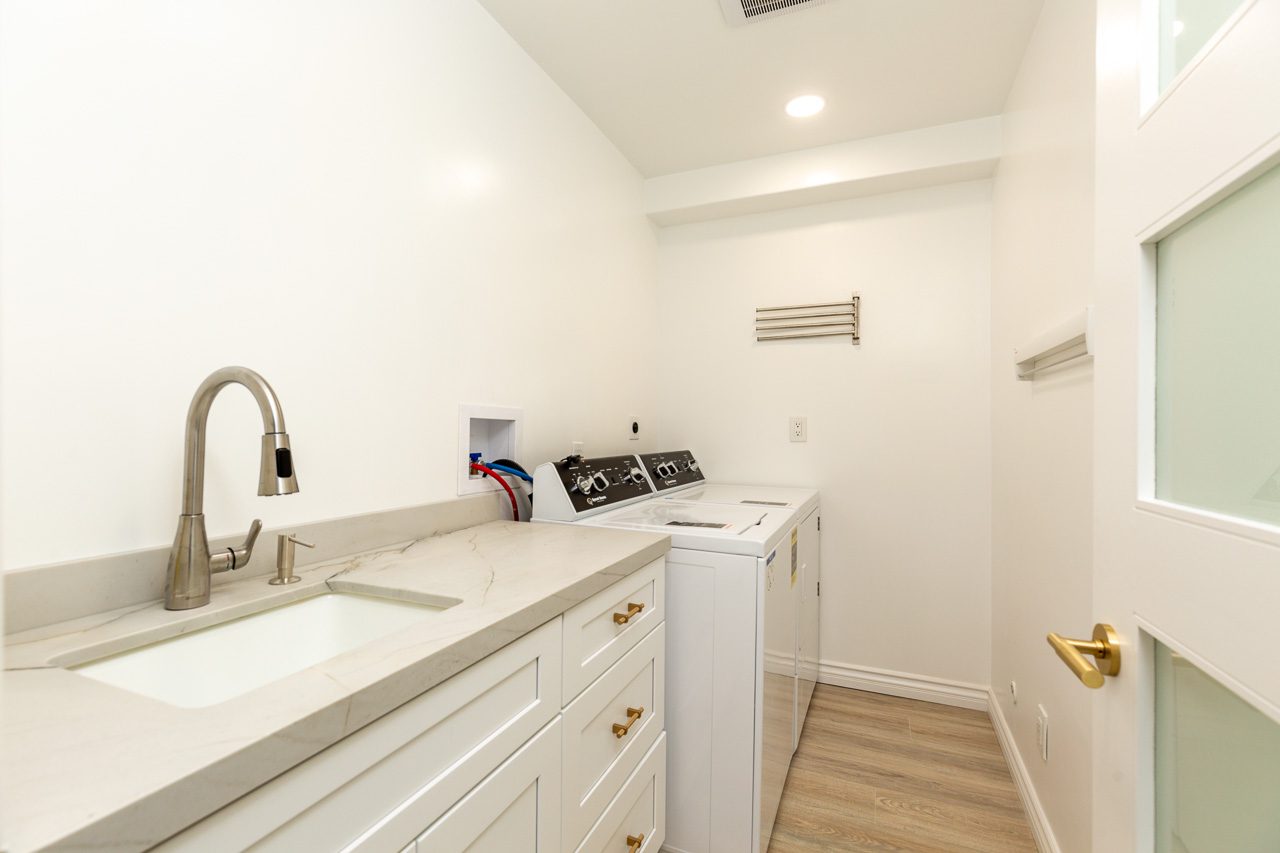 Luxury laundry room remodel custom cabinetry quartzite counter San Diego 92118