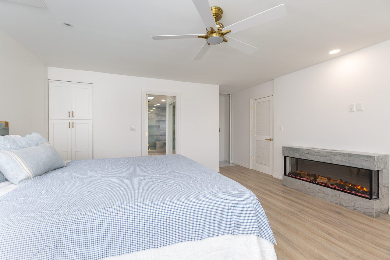 Master bedroom with fireplace LVP flooring luxury home remodel San Diego 92118