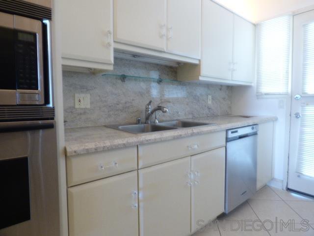 La Jolla kitchen before remodel with cream cabinets and granite counters